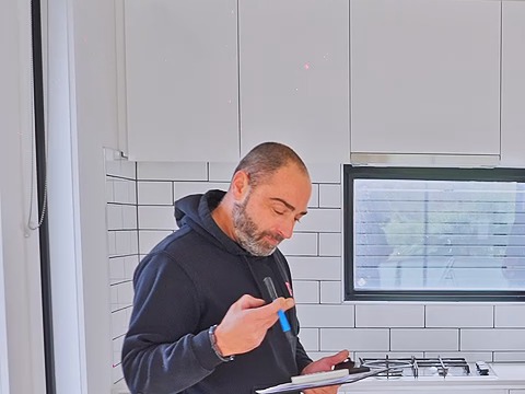 JT technician inspecting a property against the compliance standards